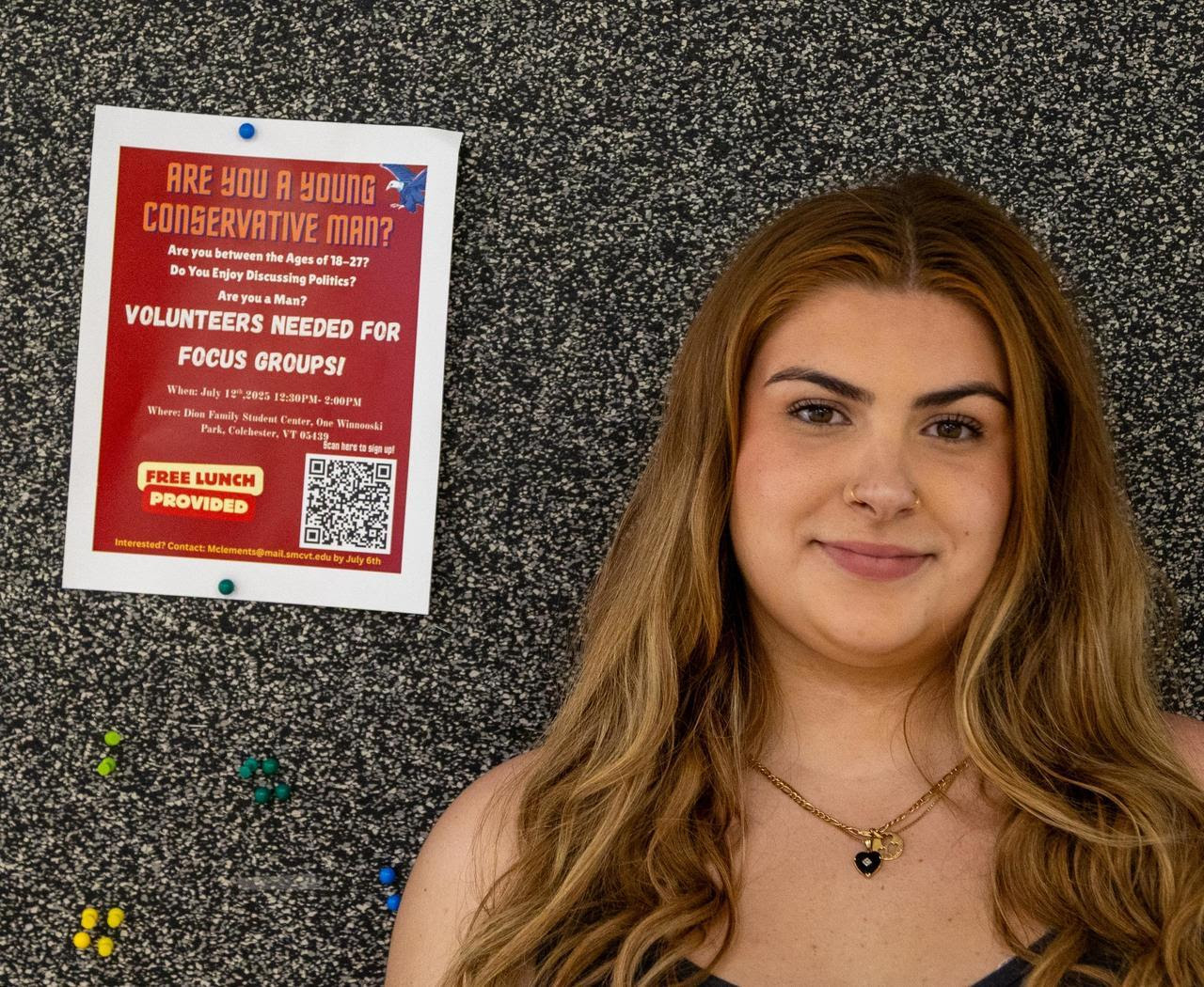 Meg Clements ’26 next to focus group flier