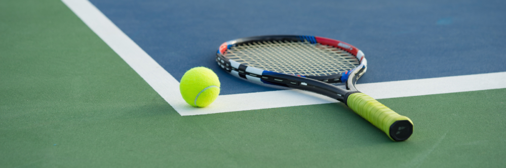 Tennis ball and racket on court