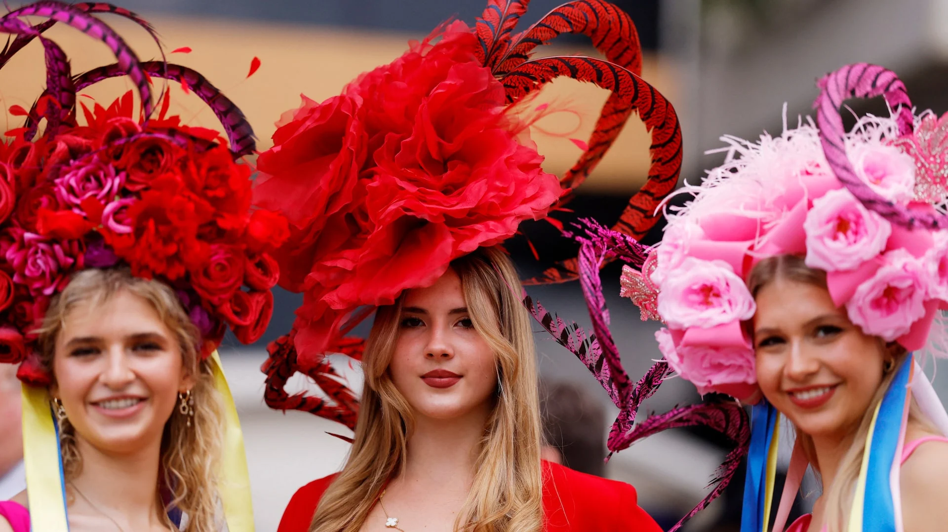 Racegoers pose for a picture ahead of the races during the Royal Ascot in Ascot, Britain, June 18, 2024.