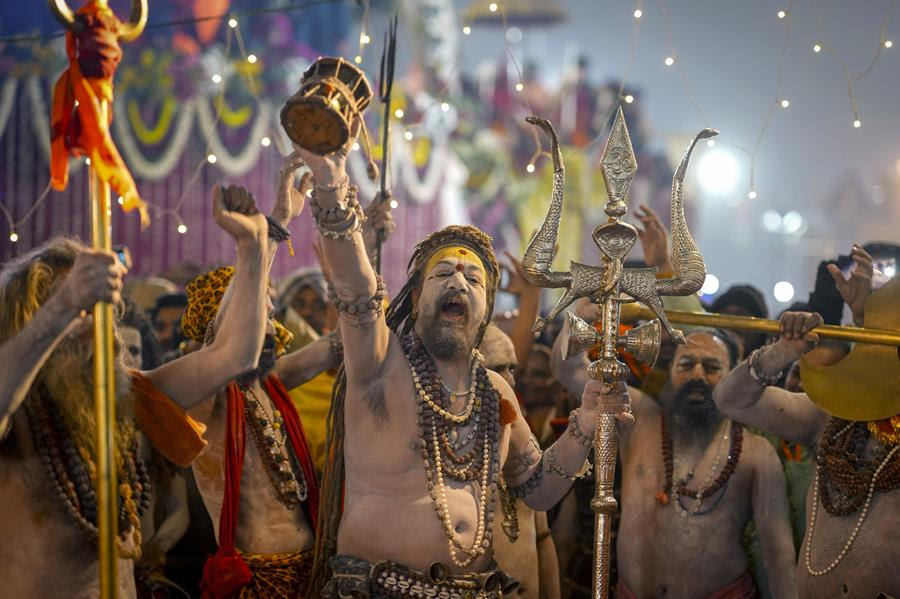 Hindu men in traditional clothing participate in the Maha Kumbh festival.