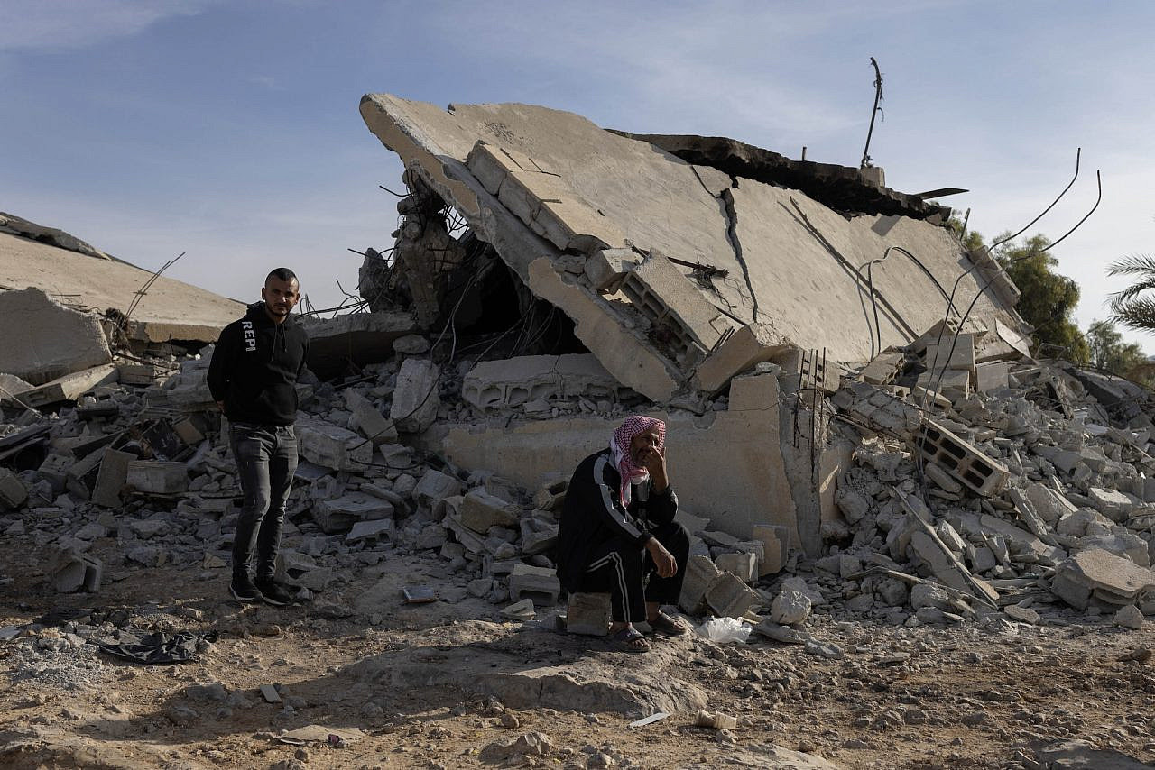 Villagers stand next to the rubble of destroyed buildings in Umm Al-Hiran, Nov. 14, 2024. (Oren Ziv)