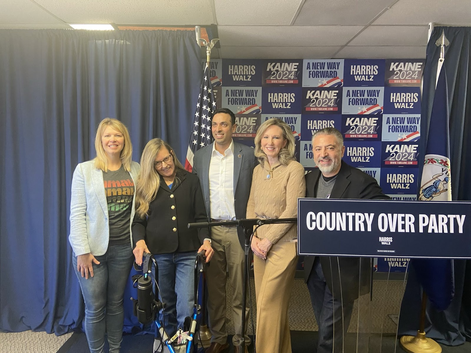 a group of people standing next to a country over party sign