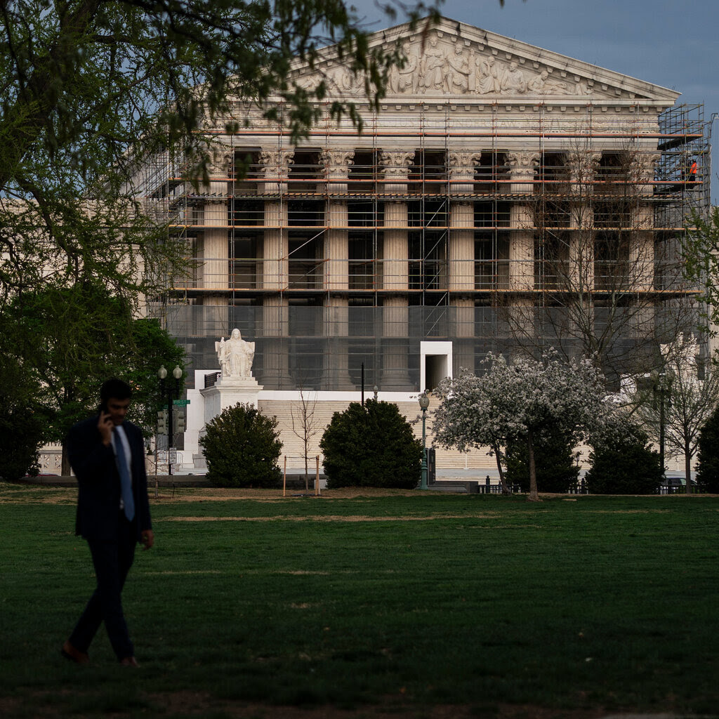 The exterior of the Supreme Court building, which has scaffolding and netting around it. 