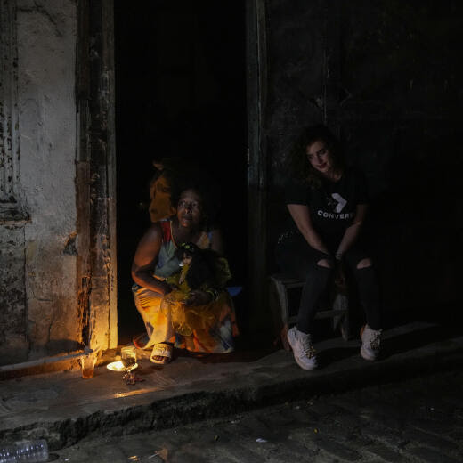 Residents pass the time during a blackout following the failure of a major power plant in Havana, Cuba, Saturday, Oct. 19, 2024. (AP Photo/Ramon Espinosa)