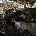 Soldiers loading a large field gun.