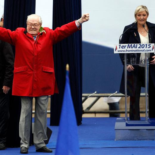 (FILES) French honorary president, former leader and founder of the French far-right party Front national (FN) Jean-Marie Le Pen gestures on stage as FN's president Marine Le Pen looks on during the party's annual rally in honour of Jeanne d'Arc (Joan of Arc), in Paris, on May 1, 2015. Jean-Marie Le Pen, a French far-right figure and runner-up in the 2002 presidential election, died on January 7, 2025, at the age of 96 in Garches (Hauts-de-Seine), in a hospital where he had been admitted for several weeks. (Photo by KENZO TRIBOUILLARD / AFP)