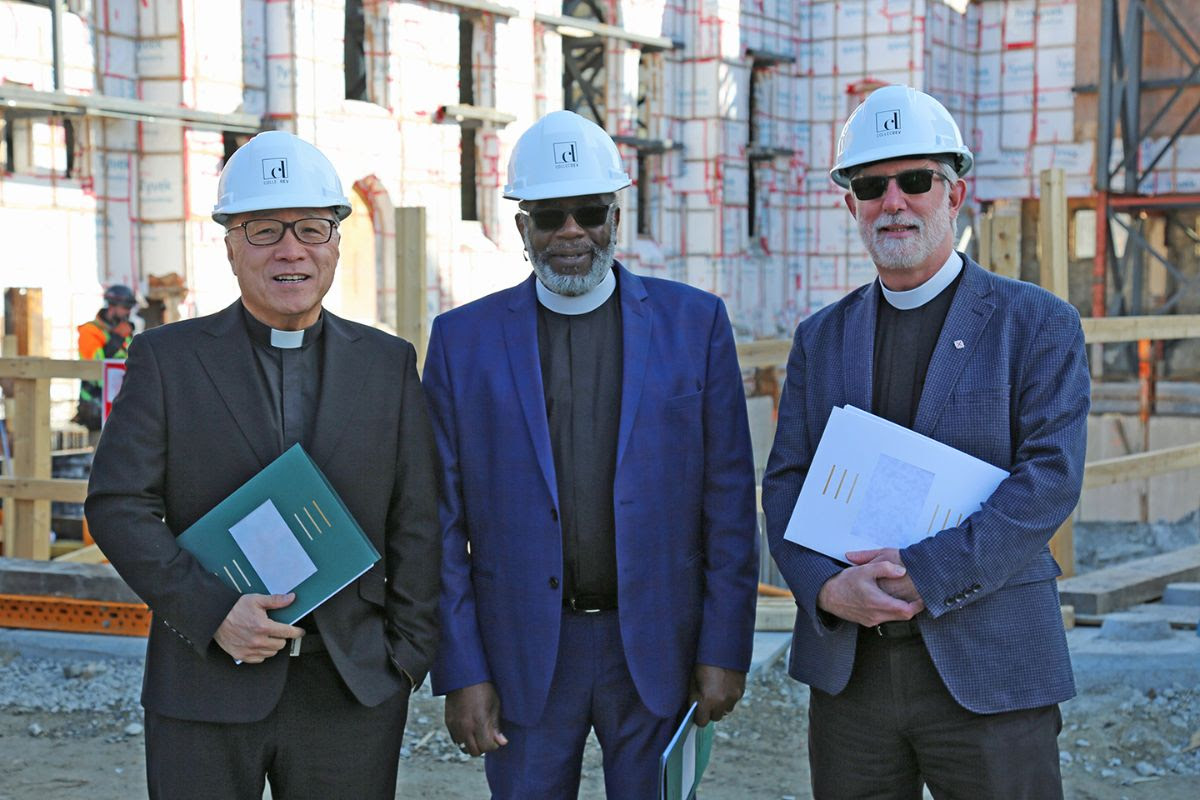 Presbyterian, Anglican, and United Church Members at Bloor Street Office Space outdoors wearing hard hats.