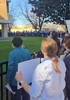 activists stretch around a the building where Thom Tillis has his office 