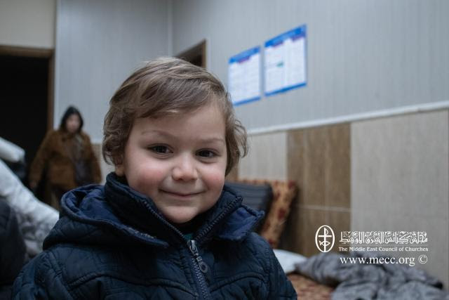 Child in Syria in a shelter getting basic needs like blankets, and supplies