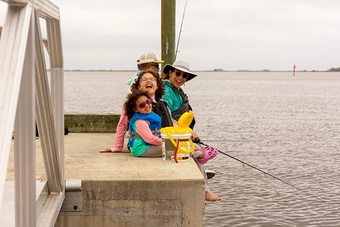 family fishing from dock