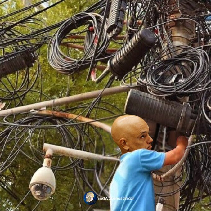 A Man trying to fix wires on pole.