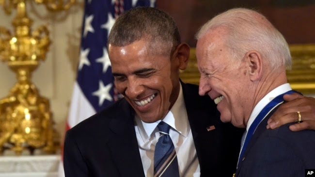 FILE - President Barack Obama laughs with Vice President Joe Biden during a ceremony in the State Dining Room of the White House in Washington, Jan. 12, 2017.