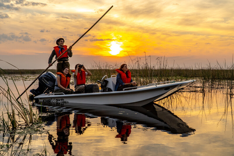 Tourists on a guided boat tour of Iberá wetlands. Photo credit: Matias Rebak