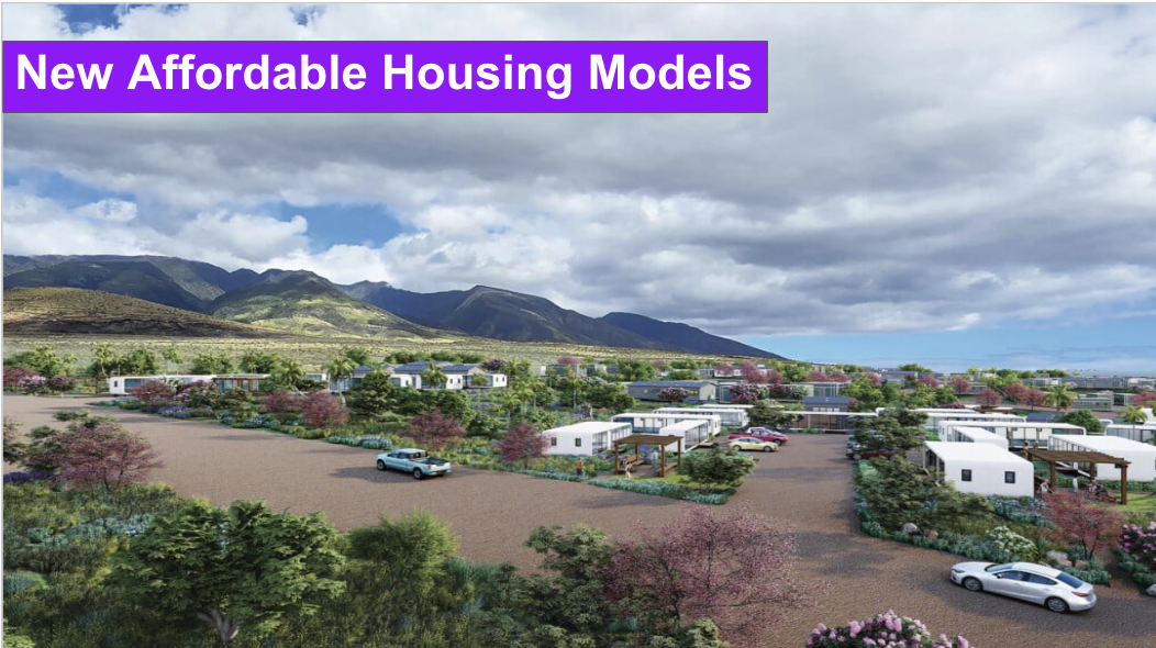 The image shows a housing development, with roads, homes, and cars on a paved road. Mountains in the distance.