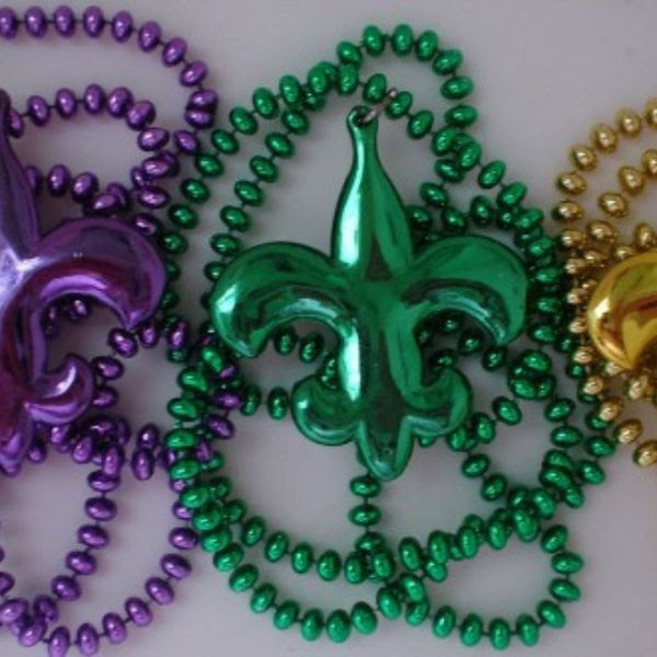 Strands of Mardi Gras beads with fleur-de-lis in purple, green, and gold