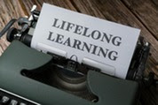 Typewriter with paper saying "LIFELONG LEARNING"