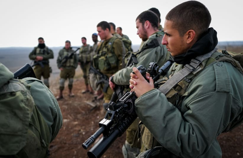  Israeli soldiers take a position in the Golan Heights, near the Israeli border with Syria, northern Israel, December 8, 2024. (photo credit: MICHAEL GILADI/FLASH90)