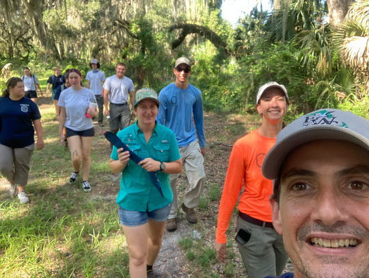 Selfie of biologist an interns walking in the woods