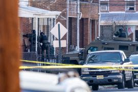 Police enter a home in Trenton, New Jersey, on March 16, 2024, after reports of a gunman, who is suspected of a shooting spree in Pennsylvania, was barricaded in a house. - An "extremely dangerous" suspect was taken into custody in New Jersey on March 16, 2024 after allegedly shooting dead three family members, authorities said, following an hours-long effort to detain him. (Photo by Joe LAMBERTI / AFP) / ALTERNATE CROP - ALTERNATE CROP