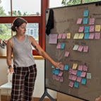 image of a person presenting at a white board
