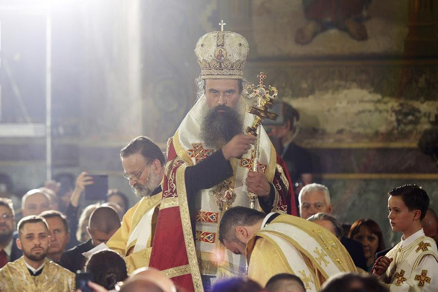 Bulgarian Patriarch Daniil stands with people gathered around him during his enthronement ceremony.