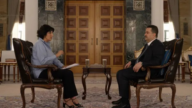 Iraqi Prime Minister Mohammed Shia al-Sudani during an interview with Nafisa Kohnavard, the BBC's Middle East correspondent. Al-Sudani sits in a chair in front of the BBC correspondent, who is also sitting in a chair.