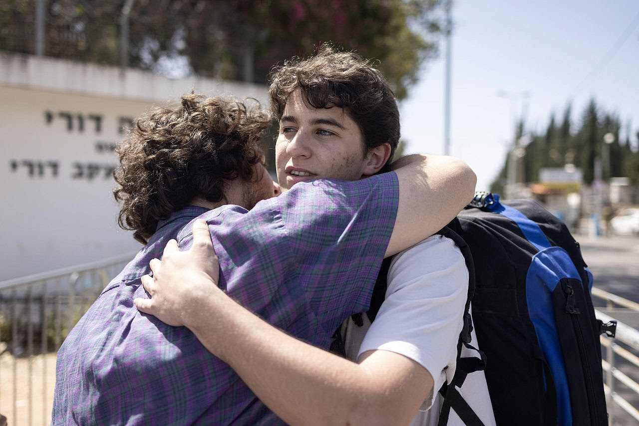 Conscientious objector Ben Arad says goodbye to friends and family as he enters the Israeli army recruitment center near Tel Aviv, April 1, 2024. (Oren Ziv)