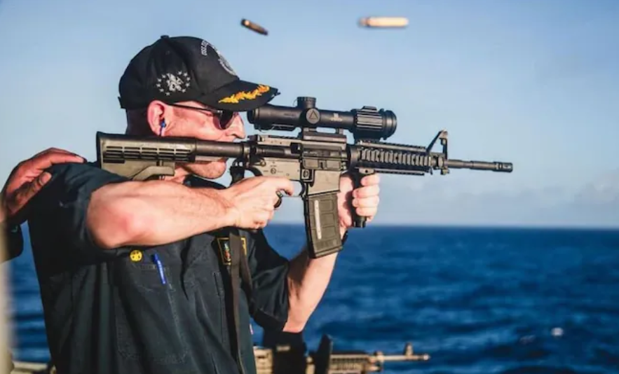 Photo showing Navy Officer shooting a gun wrong.