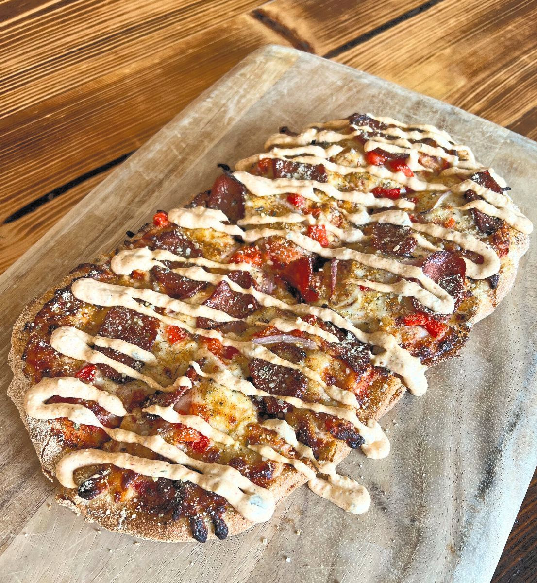 Our new Cajun Flatbread on a wood board. 
