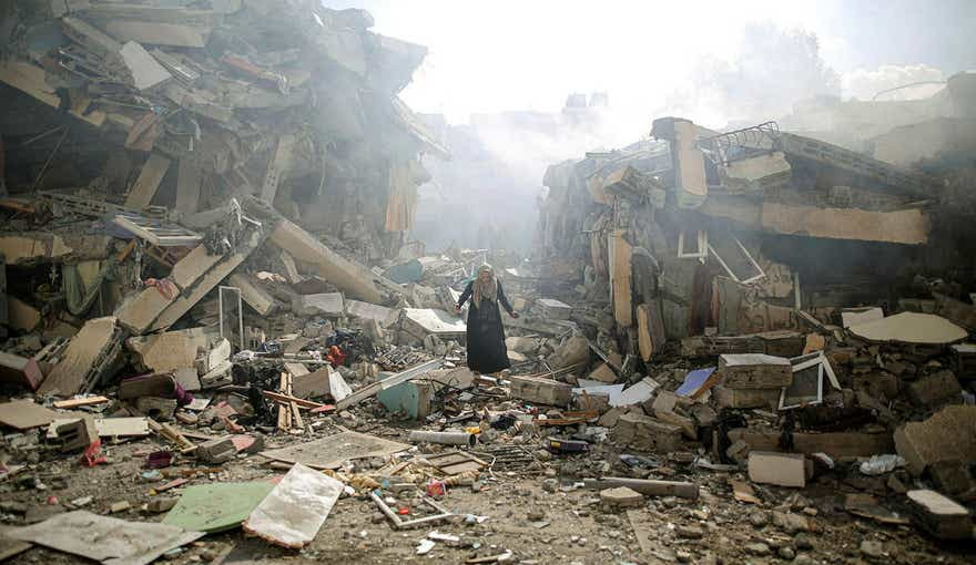 A woman in Gaza walks through the rubble of residential buildings after Israeli airstrikes on the al-Zahra neighborhood in the Gaza Strip in late October.