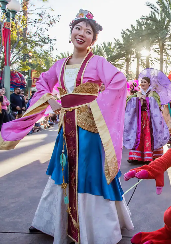 Mulan smiling while walking in Mulans Lunar New Year Procession 
