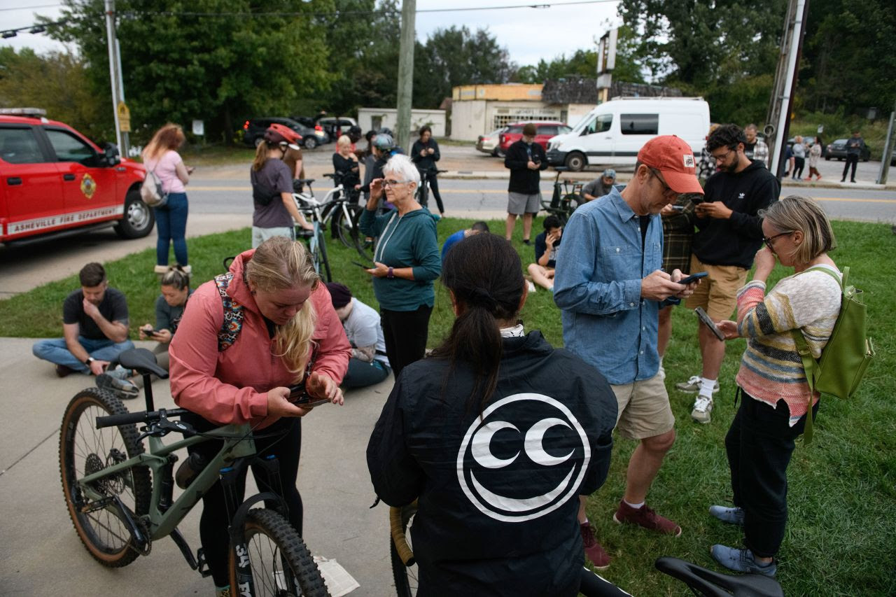 People gather at a fire station to access WiFi in Asheville, North Carolina, on Saturday.