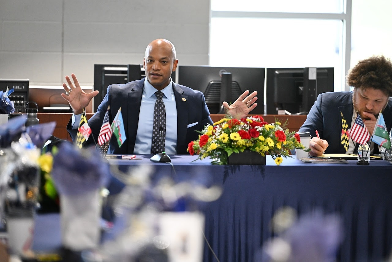 Governor Moore seated at table