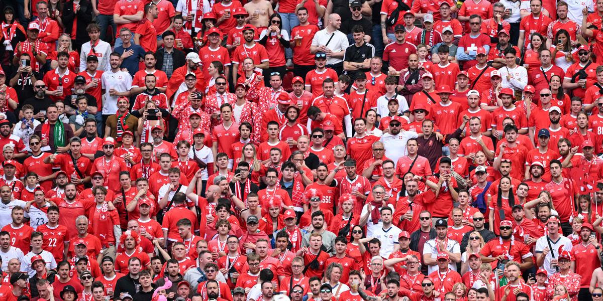 Switzerland fans react after conceding during the UEFA Euro 2024 Group A football match between Hungary and Switzerland at the Cologne Stadium in Cologne on June 15, 2024. (Photo by Kirill KUDRYAVTSEV / AFP)