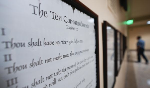 A copy of the Ten Commandments is posted along with other historical documents in a hallway of the Georgia Capitol, Thursday, June 20, 2024, in Atlanta. Christians and Jews believe in the Ten Commandments — just not necessarily the version that will hang in every public school and state-funded college classroom in Louisiana. (AP Photo/John Bazemore, File)