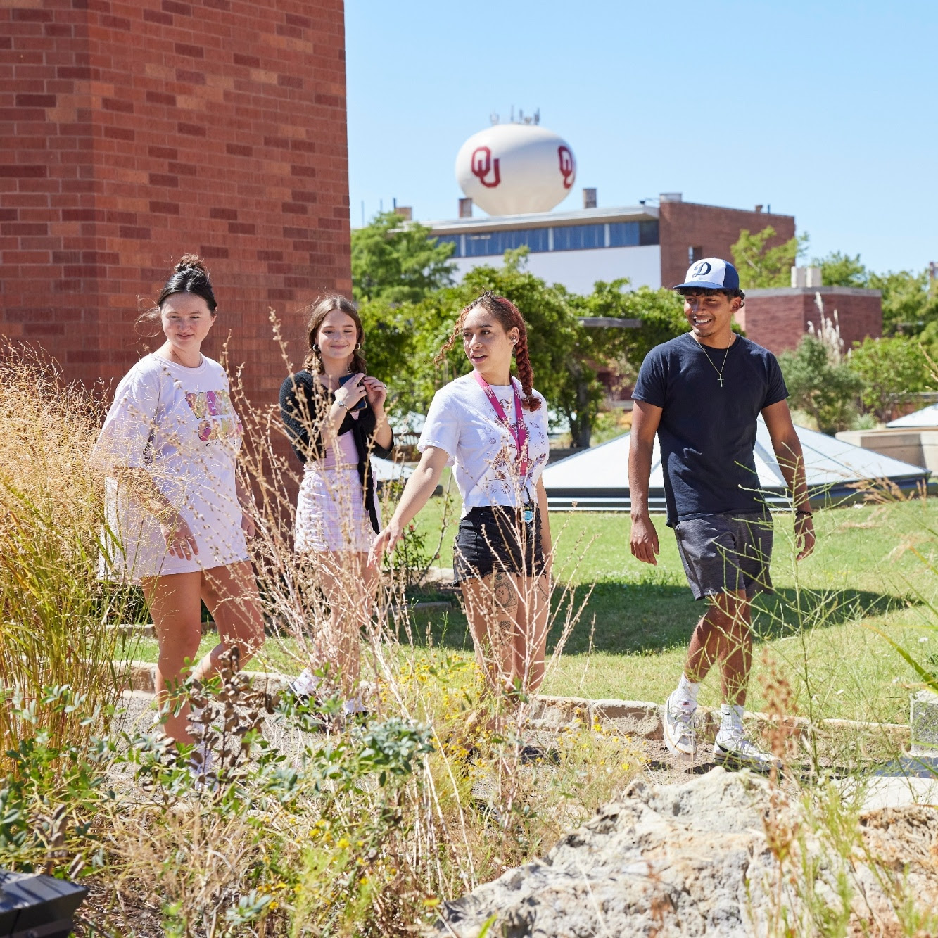 Students walking in the butterfly garden outside of Sarkey's Energy Center. 