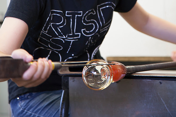 Students working in a glass blowing studio.