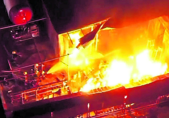 Firefighters battle a blaze at the Ramco Industries Limited compound on Shafik Drive, San Fernando, last night.