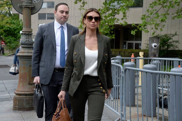 Alina Habba walks into federal court past gray barricades.