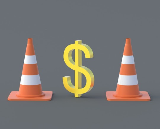 Construction cones with a dollar sign.