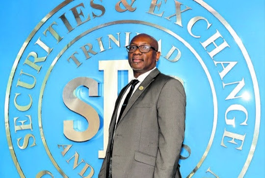 CEO of the Trinidad and Tobago Securities and Exchange Commission (TTSEC) Kester Guy in front of the commission’s sign at its offices in Tower D, Waterfront Complex, Wrightson Road, Port-of-Spain. PHOTO BY ABRAHAM DIAZ