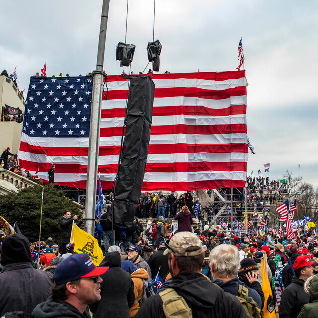A crowd of Trump supporters holding campaign flags and American flags outside the Capitol on Jan. 6, 2021.