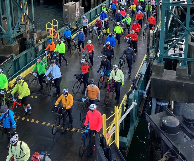 Several bicyclists boarding a ferry