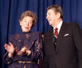 Former United Nations Ambassador Jean Kirkpatrick applauds President Reagan in this December 1988 file photo. Marcy Nighswander | Associated Press