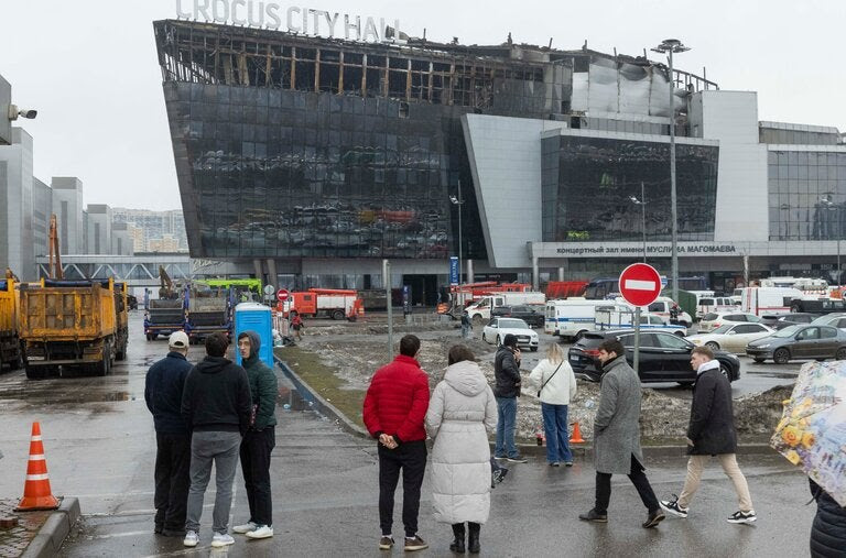 People gathered outside Crocus City Hall outside Moscow after the terrorist attack there last month. Russia charged four migrant laborers from Tajikistan with the assault.