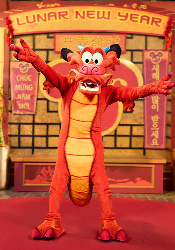 Mushu in front of a Lunar New Year photo backdrop