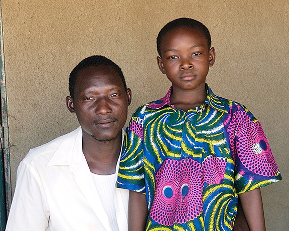 A photo of a man and a child looking at the camera