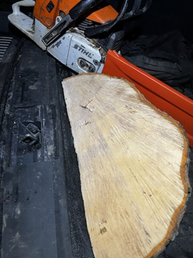 Chainsaw and cut wood in a vehicle.