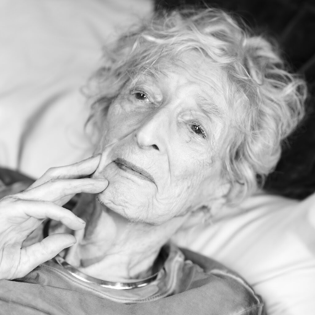 A black-and-white photograph of Lore Segal lying down.