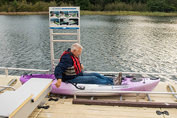 A man uses an accessible kayak launch to enjoy some time on the water.